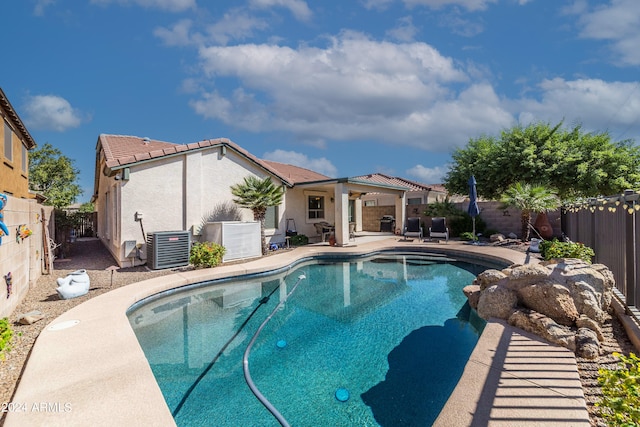 view of pool with a patio and central AC unit