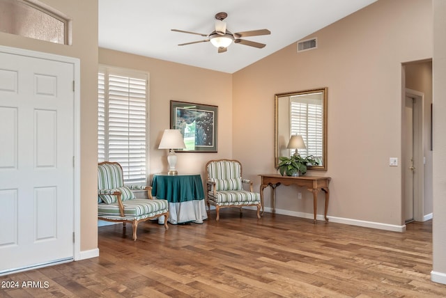 living area featuring lofted ceiling, hardwood / wood-style floors, and ceiling fan