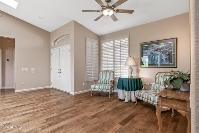 sitting room with ceiling fan, lofted ceiling, and light hardwood / wood-style floors