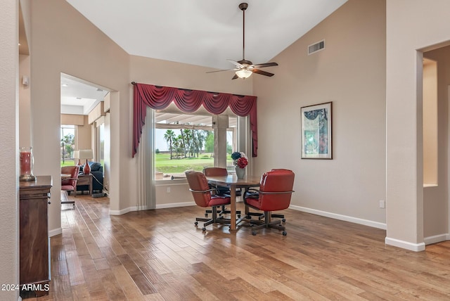 dining space featuring high vaulted ceiling, light hardwood / wood-style floors, and ceiling fan