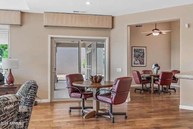 dining space featuring hardwood / wood-style flooring and ceiling fan