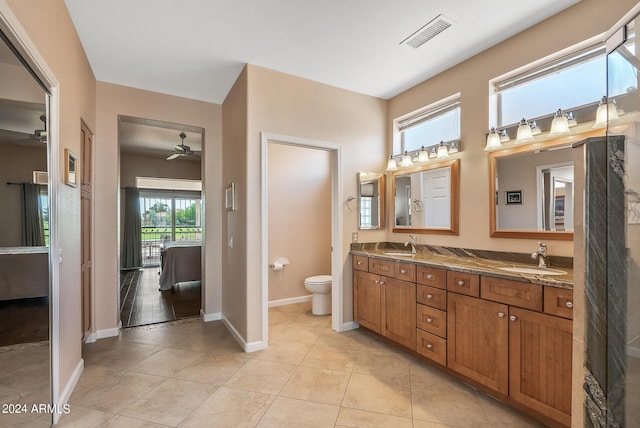 bathroom with tile patterned flooring, vanity, ceiling fan, and toilet