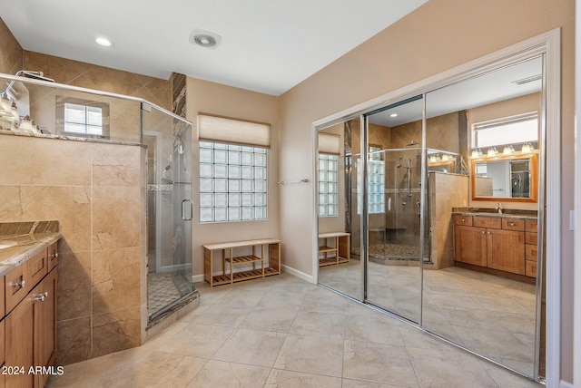 bathroom featuring walk in shower and vanity