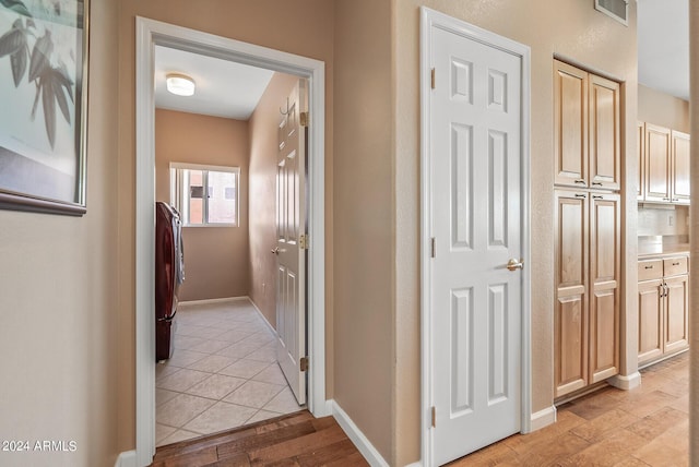 hall featuring separate washer and dryer and light hardwood / wood-style flooring