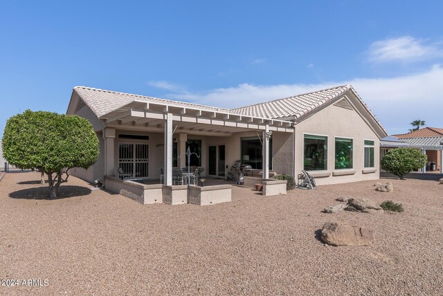 rear view of house with a pergola and a patio area