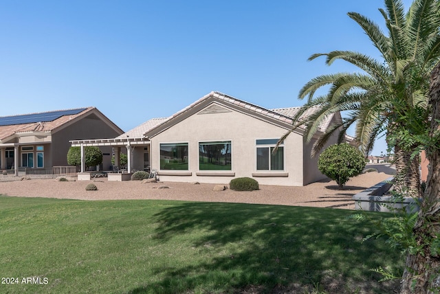 rear view of house with a lawn and a patio area