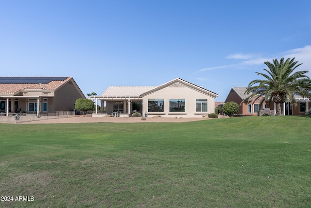 rear view of property featuring a yard