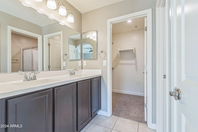 bathroom featuring tile patterned flooring, vanity, and an enclosed shower