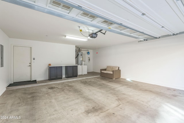 garage featuring electric water heater and a garage door opener