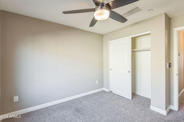 unfurnished bedroom with ceiling fan, a closet, and light colored carpet