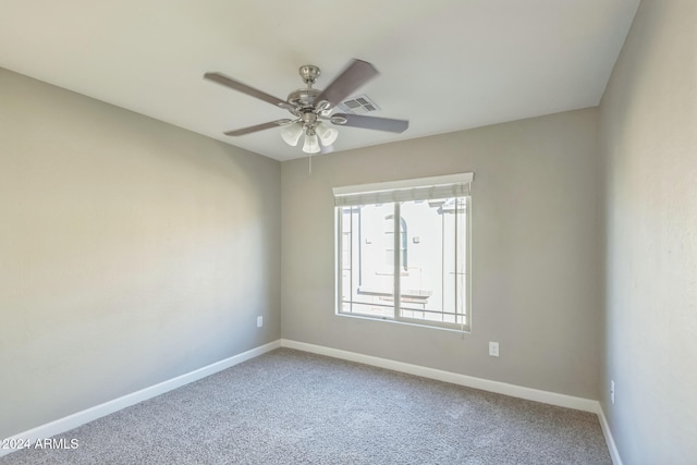 unfurnished room with ceiling fan and carpet