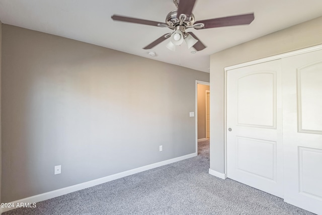 unfurnished bedroom featuring a closet, ceiling fan, and light colored carpet