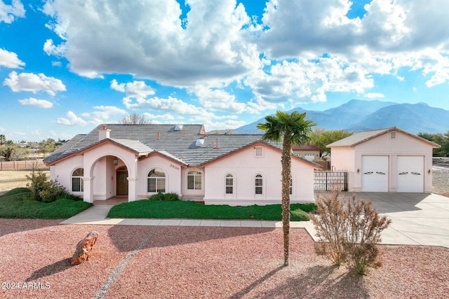 view of front of house featuring a mountain view, an outbuilding, and a garage