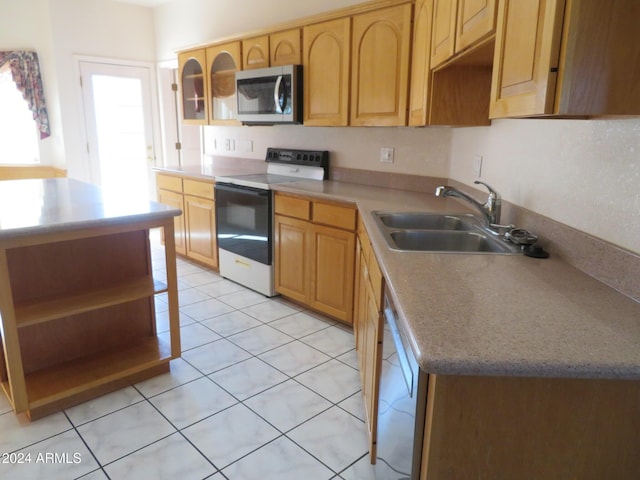 kitchen with light tile patterned floors, white appliances, and sink