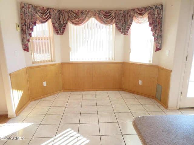 tiled spare room with wood walls