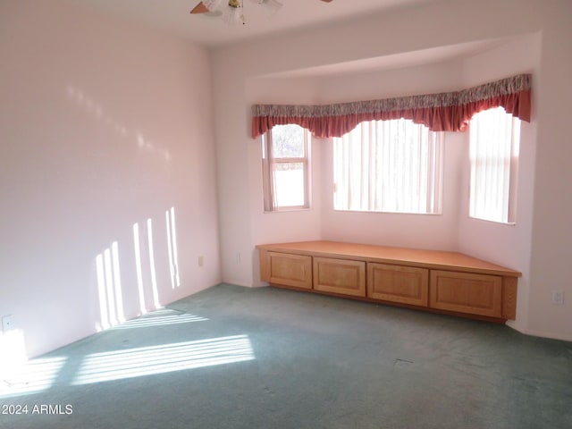 unfurnished room featuring carpet floors and ceiling fan