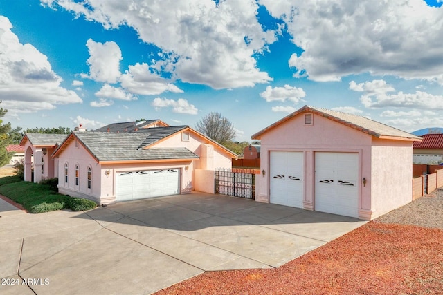 view of front of property with a garage and an outdoor structure