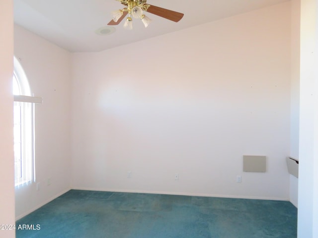 carpeted spare room with ceiling fan