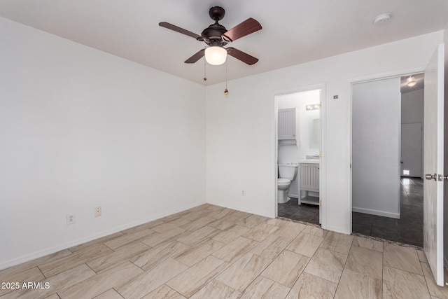 unfurnished bedroom featuring ensuite bath and ceiling fan