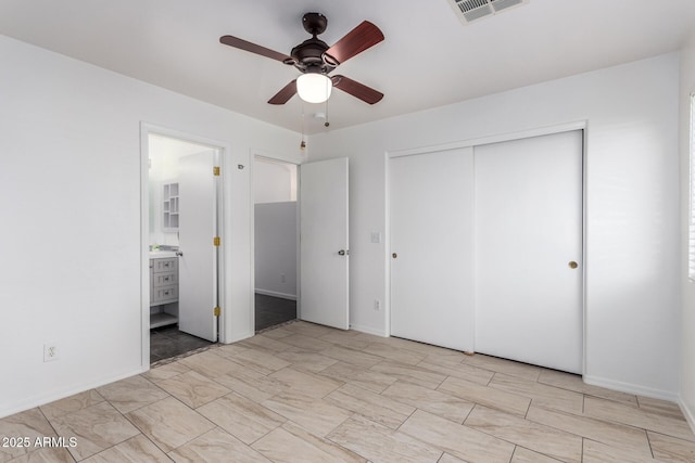 unfurnished bedroom featuring a closet, ceiling fan, and ensuite bathroom