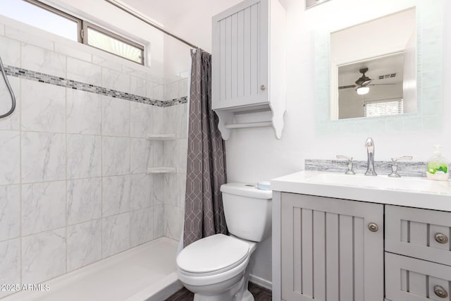 bathroom featuring vanity, ceiling fan, toilet, and a shower with shower curtain