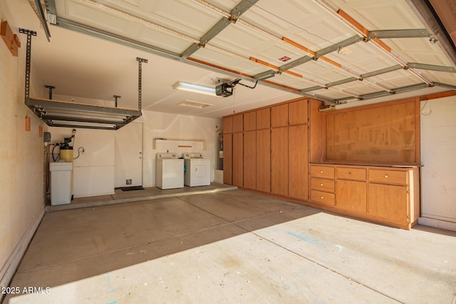 garage with a garage door opener and washer and clothes dryer