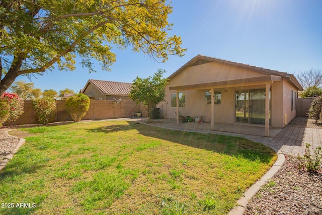 back of house featuring a yard, central AC unit, and a patio area