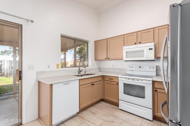 kitchen featuring a high ceiling, sink, and white appliances