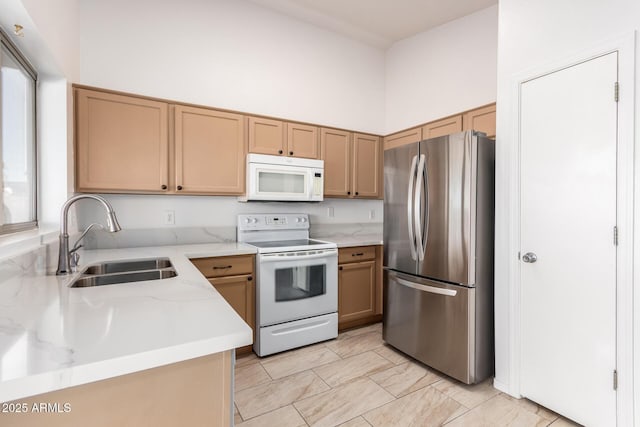 kitchen with a high ceiling, sink, and white appliances