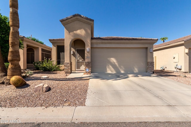 view of front of property featuring a garage, stone siding, concrete driveway, and stucco siding