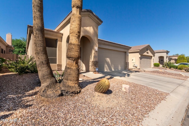 mediterranean / spanish-style home with concrete driveway, a garage, and stucco siding