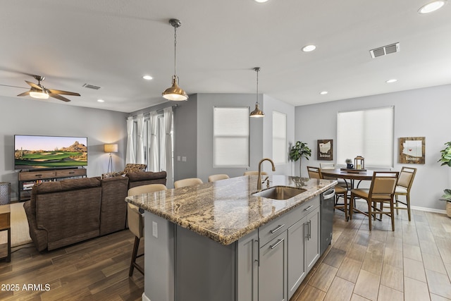 18865 W Mescal St, Surprise, AZ 85388 - kitchen with gray cabinets, stainless steel dishwasher, open floor plan, light stone countertops, and ceiling fan