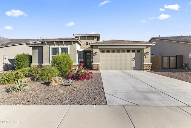 18865 W Mescal St, Surprise, AZ 85388 - prairie-style house featuring an attached garage, concrete driveway, stucco siding, and stone siding