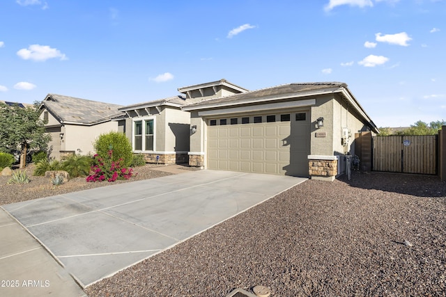 18865 W Mescal St, Surprise, AZ 85388 - view of front facade featuring stone siding, a garage, a gate, stucco siding, and driveway