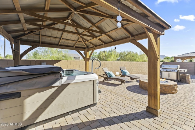 18865 W Mescal St, Surprise, AZ 85388 - fenced backyard featuring a gazebo, an outdoor fire pit, a grill, a hot tub, and a patio
