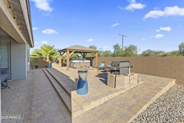 18865 W Mescal St, Surprise, AZ 85388 - fenced backyard featuring a hot tub, a grill, a patio, and a gazebo