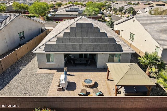 18865 W Mescal St, Surprise, AZ 85388 - rear view of house featuring a residential view, solar panels, a fenced backyard, a patio, and stucco siding