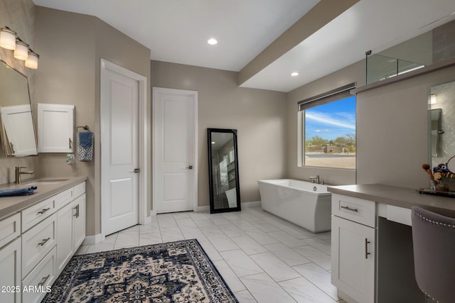 full bathroom featuring baseboards, recessed lighting, a freestanding tub, an enclosed shower, and vanity