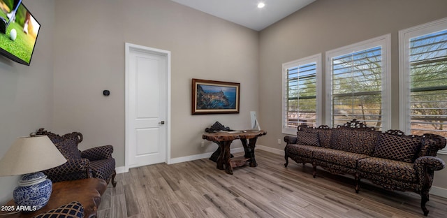 living area with recessed lighting, light wood-style floors, and baseboards