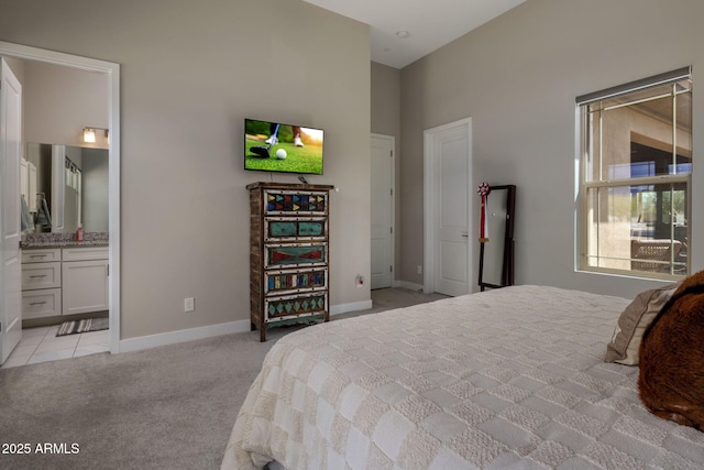 bedroom with light tile patterned floors, baseboards, and light carpet