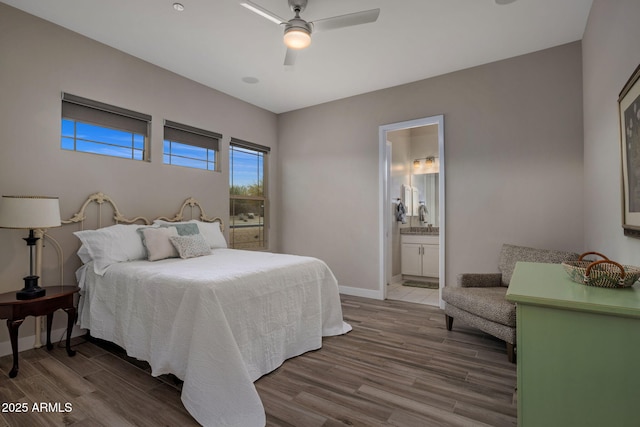 bedroom with wood finished floors, baseboards, ensuite bathroom, and ceiling fan