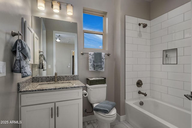 bathroom featuring shower / washtub combination, toilet, vanity, and baseboards