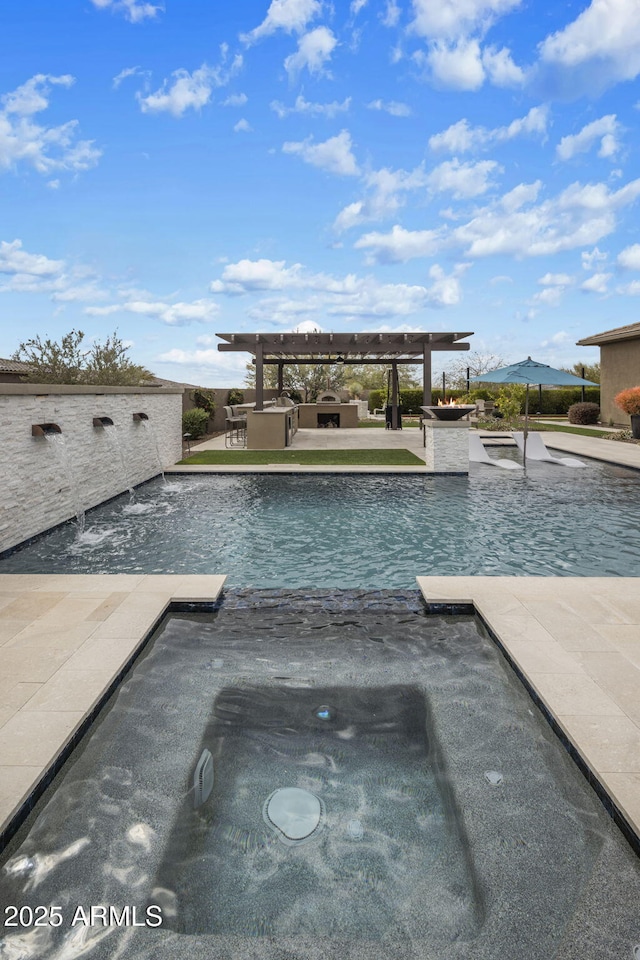 view of swimming pool with a patio and a pool with connected hot tub