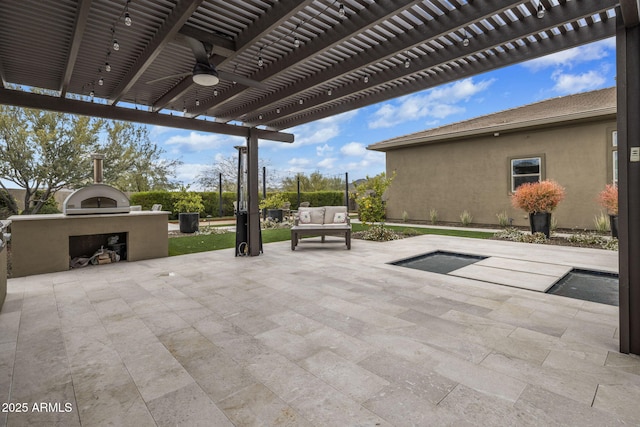 view of patio / terrace featuring a ceiling fan, fence, a fireplace, and a pergola