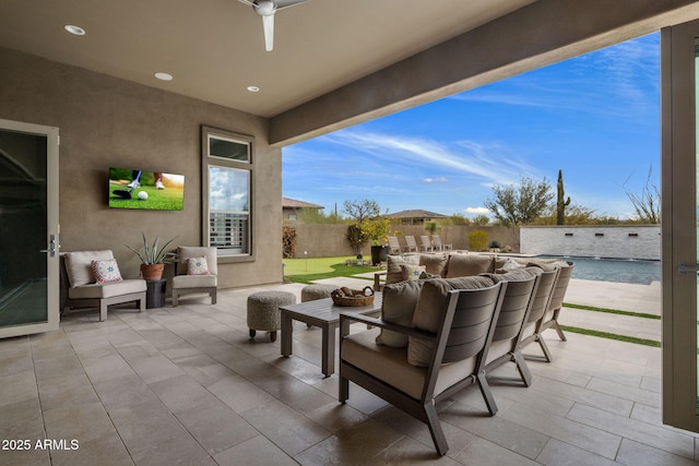 view of patio with an outdoor living space and fence