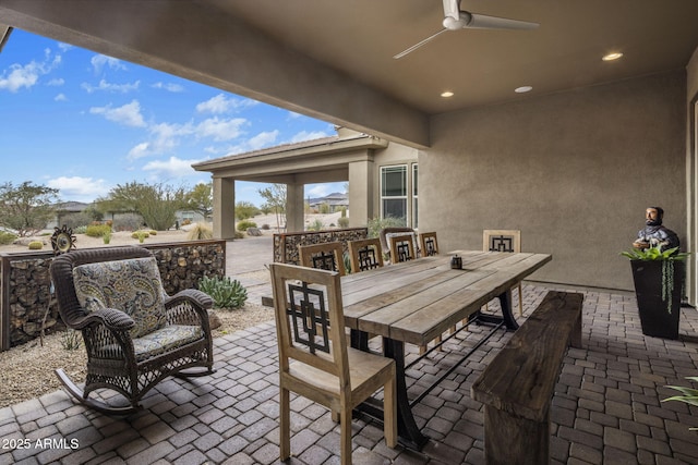 view of patio / terrace featuring outdoor dining space and a ceiling fan