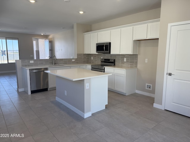 23214 W Miami St, Buckeye, AZ 85326 - kitchen featuring stainless steel appliances, decorative backsplash, white cabinetry, a center island, and recessed lighting