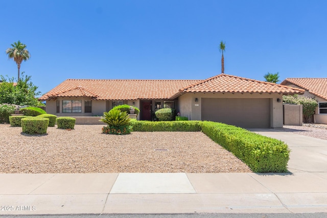 6017 E Kathleen Rd, Scottsdale, AZ 85254 - view of front of home with a tiled roof, stucco siding, an attached garage, and concrete driveway