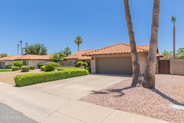 6017 E Kathleen Rd, Scottsdale, AZ 85254 - view of front facade featuring stucco siding, a garage, concrete driveway, a tile roof, and a gate