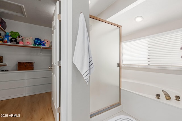 6017 E Kathleen Rd, Scottsdale, AZ 85254 - bathroom featuring a shower stall, wood finished floors, a garden tub, and a closet